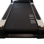 Close-up of a treadmill belt and side rails, showing the textured running surface.