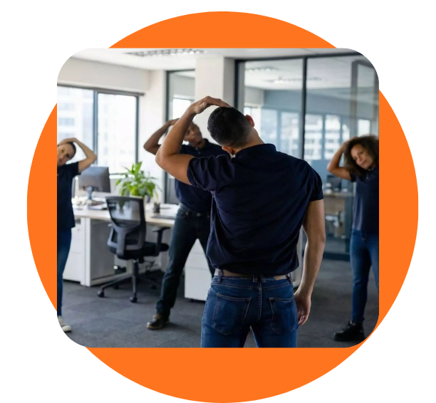 Group of coworkers in an office stretching their necks together, facing away from the camera.