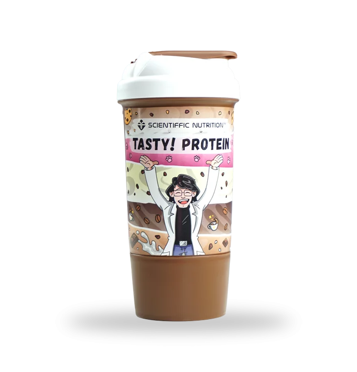 Shaker-Tasty Protein shaker bottle labeled 'Tasty! Protein' with a cheering cartoon character on the wrap, chocolate-brown drink visible inside.