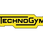 TechnoGym logo: bold black lettering on a yellow angular badge with a stepped border.
