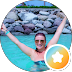 Man in a pool with arms raised, wearing sunglasses, circular frame with an orange star badge overlay indicating achievement.
